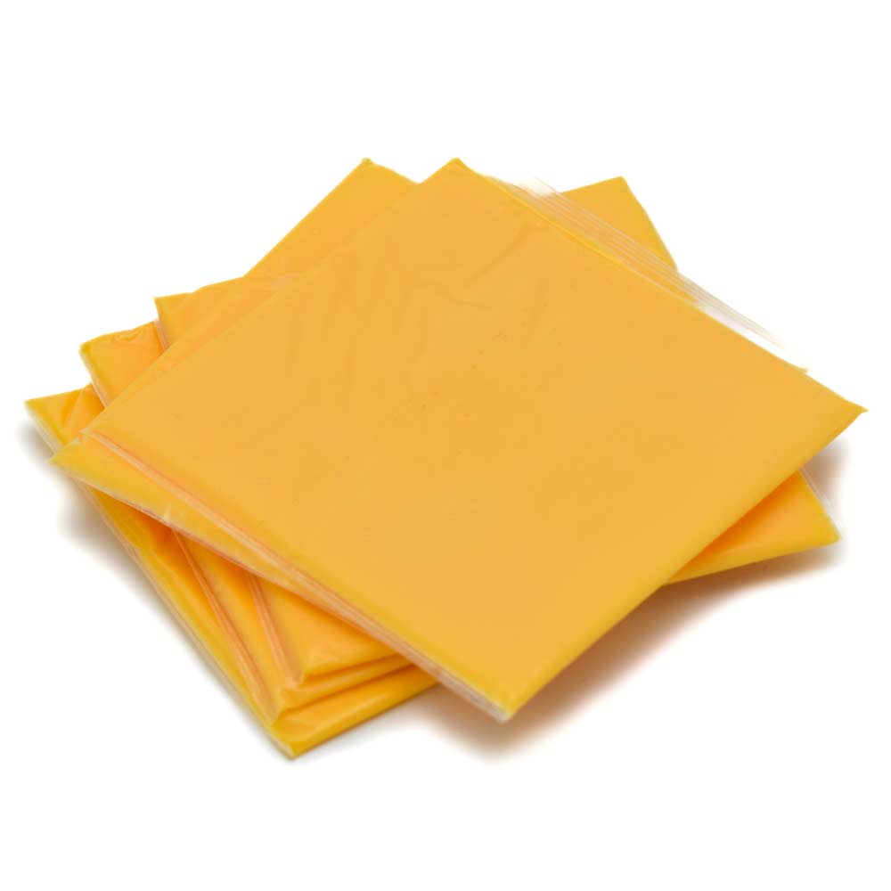 Stack of yellow cheese slices on a white background.