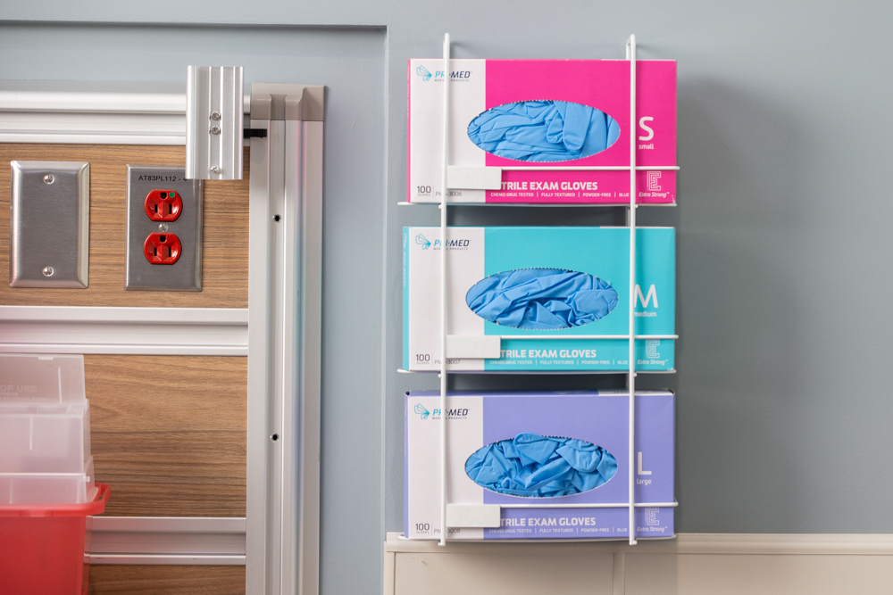 Pink, blue, and, purple Nitrile glove boxes. The pink box has small gloves, the blue box has medium gloves, and the purple box has large gloves.