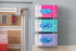 Pink, blue, and, purple Nitrile glove boxes. The pink box has small gloves, the blue box has medium gloves, and the purple box has large gloves.