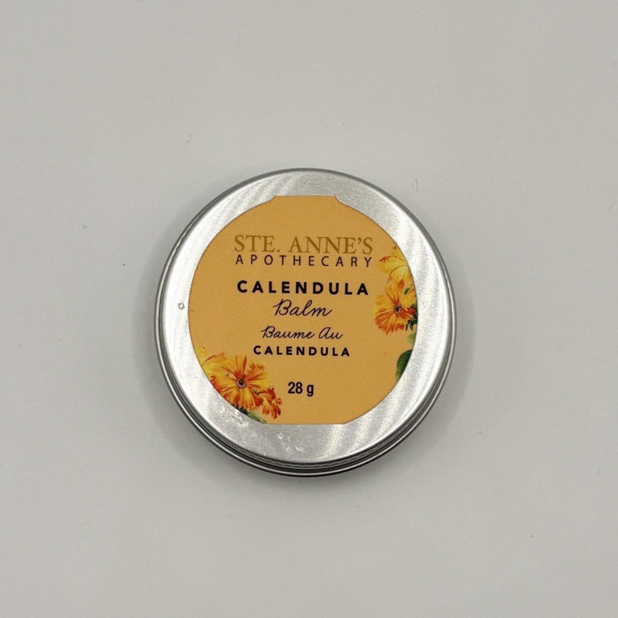 Ste Anne's Calendula Balm in silver tin with orange label. 28 grams. 