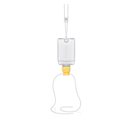 Medela Supplemental Nursing System, clear bag with yellow attachment, two clear tubes extending out.